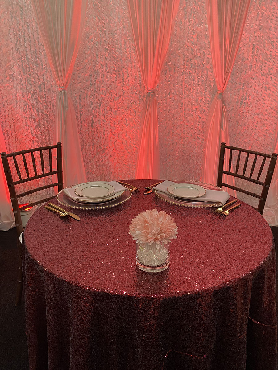 Gatsby Backdrop with White Polyknit Front Layer Single Tied with Uplights with Gels